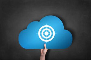 businessman is holding a blue cloud target icon on black blackboard